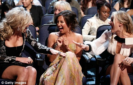 What's so funny? Ashley and Alyson Michalka appeared to be in hysterics during the show as they shared a joke with Alison's sister Amanda