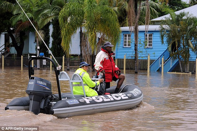 On the look out: Police officers patrol the streets of Rockhampton to deter would-be looters