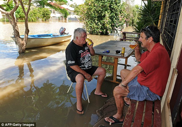 Defiant: Two men enjoy a beer as they sit outside the Pioneer Hotel in Rockhampton