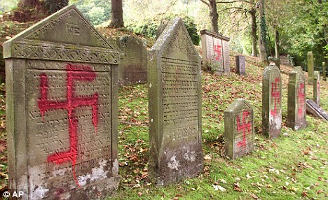 Defiled: Gravestones were sprayed with swastikas at the Jewish cemetery in Schwaebisch Hall, southern Germany, in October 2000