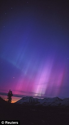 Illuminated: The night sky in Eureka, Alaska, was lit up in 2003 after a solar storm hit the earth. The London Olympics could also be affected, the Met Office have admitted