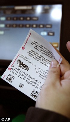 Unlucky this time: A player examines their numbers ahead of the draw. Today, the winners were revealed as a Washington man and an Idaho resident