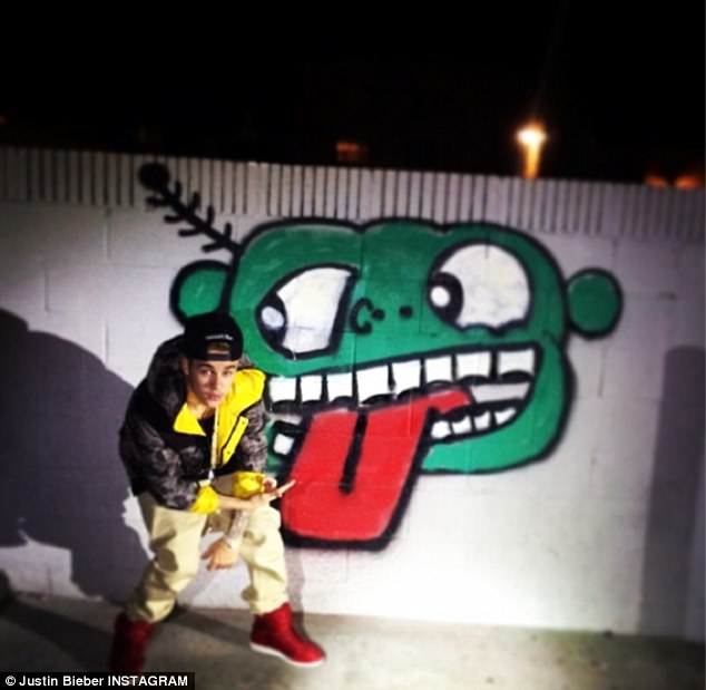 Art attack: The pop superstar posed next to graffiti in downtown Los Angeles