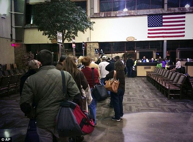 Here, passengers line up Sunday to board a new flight after being taken to a small Missouri town by mistake