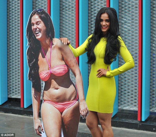 What an achievement: Wearing her long raven locks tousled into loose waves, the bona fide gym bunny completed her sexy look with a slick of lipstick