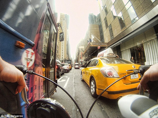 Tight fit: The bike allows Sklyarov to squeeze through the city's never-ending gridlock