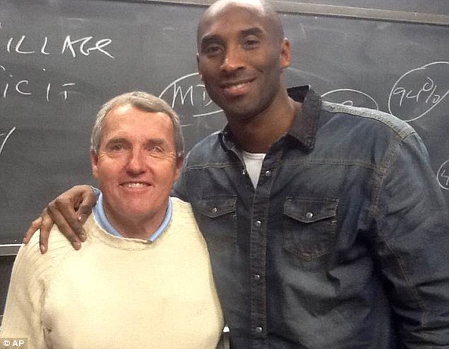 Teacher's pet: Los Angeles Lakers star Kobe Bryant - currently in recovery for knee surgery - mad ea surprise appearance at a Boston College marketing class being given by professor Nick Nugent (left)