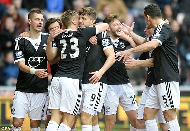 All smiles: Southampton players celebrate Jay Rodriguez's opener during Saturday's 2-2 draw with Sunderland