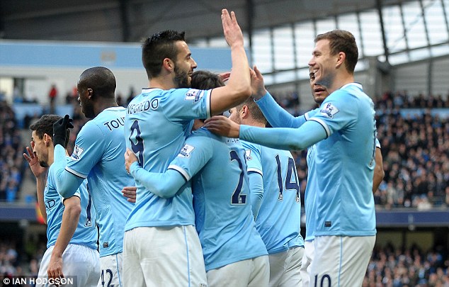 High five: Edin Dzeko (right), pictured being congratulated by Alvaro Negredo, scored Man City's 100th goal of the season