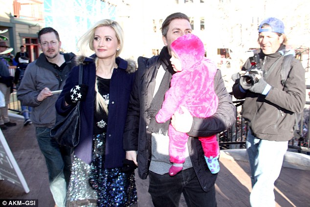 Staying warm: The former reality star bundled up in a a navy blue pea coat with a fur trimmed hood