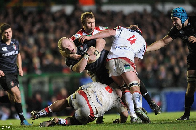 Man-handled: Tigers prop Dan Cole is tackled by Ulster's Roger Wilson, Nick Williams and Johann Muller