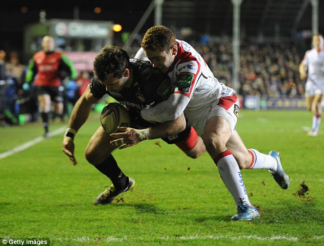 Touch and go: Leicester's Irish winger Niall Morris is wrapped up by Paddy Jackson before the try line