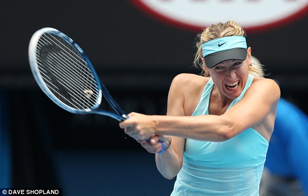 With a grimace: Sharapova heaves a backhand down the line