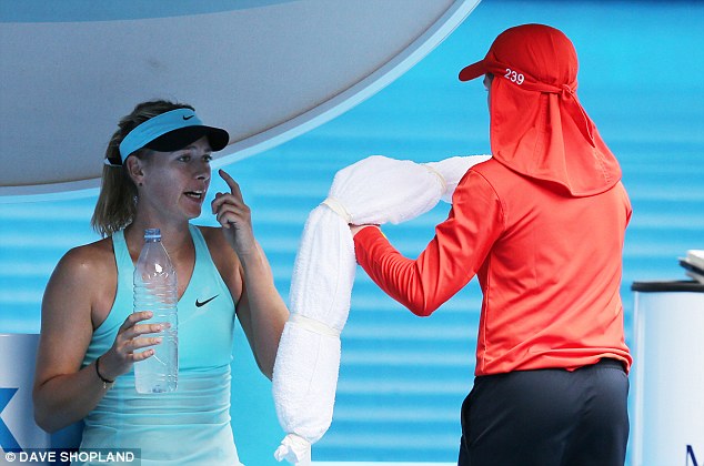 Beating the heat: The No 3 seed wraps a cooling towel around herself between games