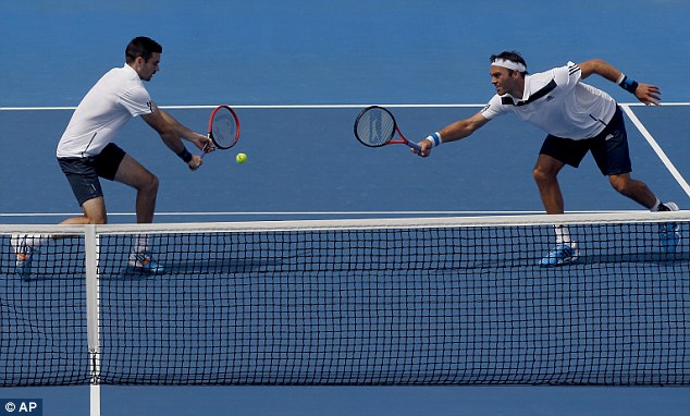 On the stretch: Hutchins (right) and Fleming reach to return the ball