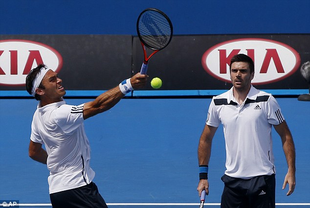 Back in action: Ross Hutchins plays a volley during his match alongside Colin Fleming