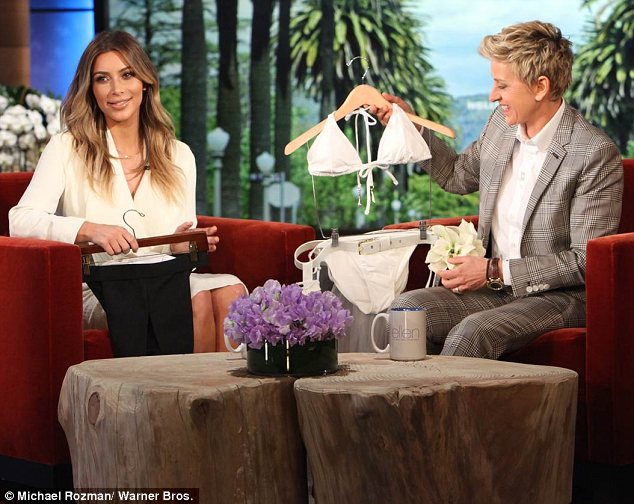 An early wedding gift: Ellen presented Kim with bride and groom swimwear, which the reality star was delighted by