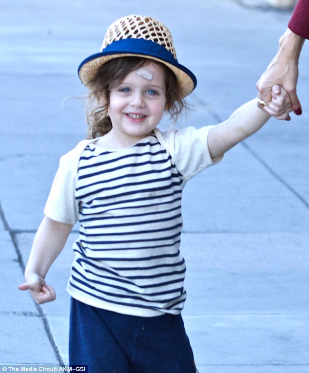 Little sailor! The adorable two-year-old - sporting a plaster on his forehead - wore a nautical striped shirt and trousers which brought out his baby blues