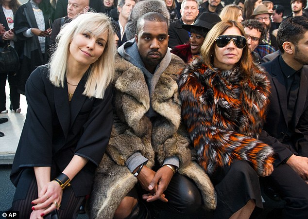 Squished? Kanye attended the Givenchy runway show in Paris on Friday without Kim but instead with Carine Roitfeld and Noomi Rapace sticking rather close to the rapper's sides