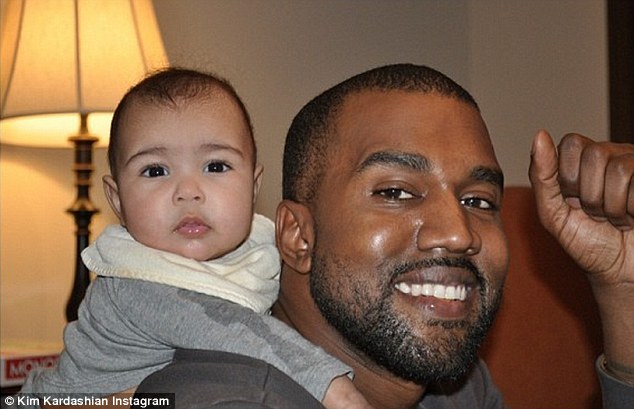 'My family!' Kim Kardashian proudly shared this photo of her fiance Kanye West giving their baby daughter North West a piggyback ride