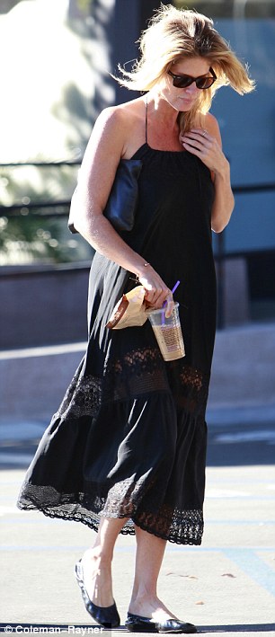 Effortlessly chic: The New Zealand supermodel looked elegant in a loose cotton black dress and ballet slippers