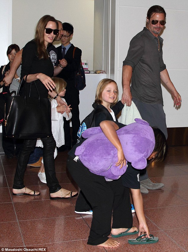 Jet setting clan: Brad, Angie and the six kids arrived at an airport in Japan back in July