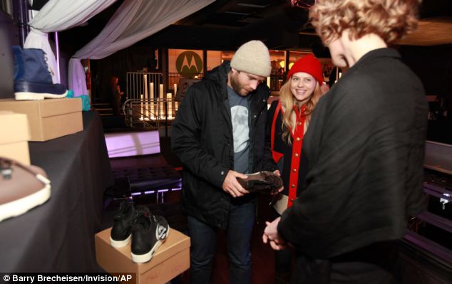 Happy couple: Mark and Teresa look over a few items at a Day Lounge at the festival before the premiere. The two enjoyed spending time dressed down together before the big event