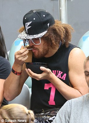 Tucking in: Redfoo watches Victoria Azarenka make serene progress into the next round