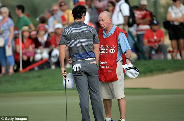 Rules are rules:: McIlroy (left) in deep conversation about an apparent incorrect drop at the second hole