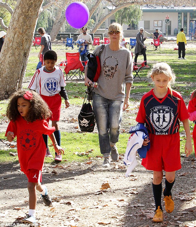 Family fun: Heidi was casually dressed for a day out playing soccer with her children in November