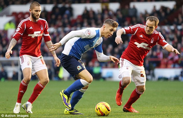 In action: Rovers' Tom Cairney (centre) takes the ball past David Vaughan (right) and Lansbury