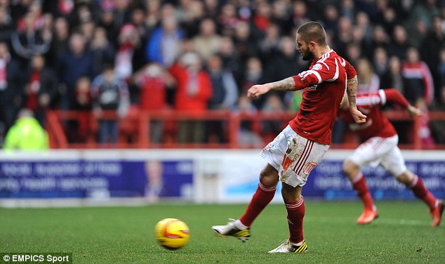 On the spot: Henri Lansbury scores his first penalty of the afternoon to give Nottingham Forest the lead