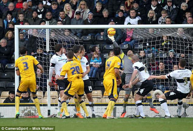 Fingertips: Derby keeper Lee Grant keeps the shot of Brighton's Matthew Upson out with a reflex save