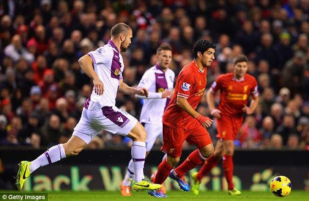 Nowhere to go: Suarez dribbles away from Villa's Ron Vlaar