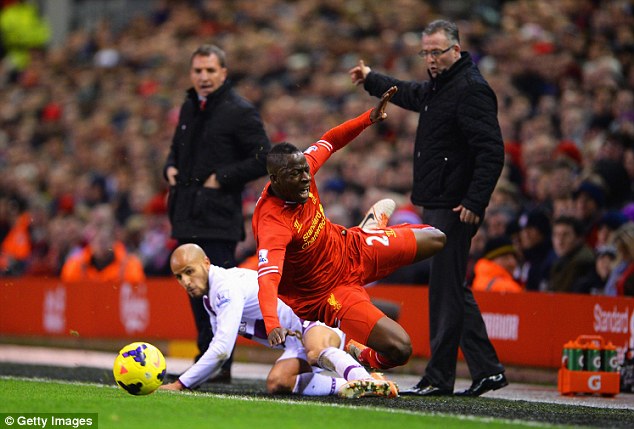 Close call: Cissokho is challenged by Karim El Ahmadi under the noses of Paul Lambert and Brendan Rodgers