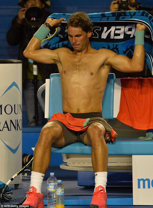 Toned: Nadal shows off his physique as he towels off between games