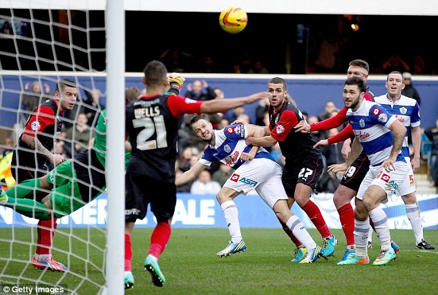 Going close: QPR's Clint Hill looks on as Terriers keeper Alex Smithies palms away his goalbound header