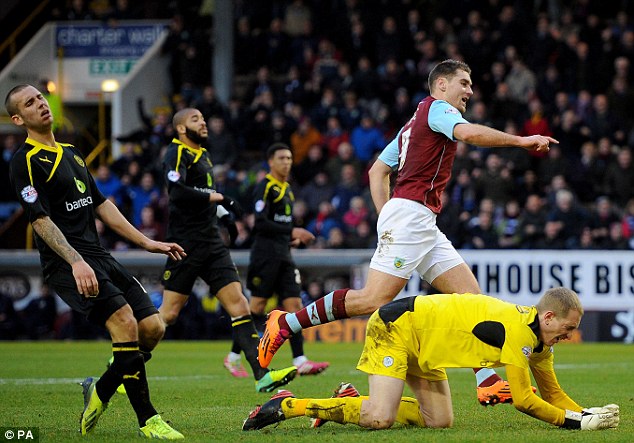 Ahead: Burnley striker Sam Vokes wheels away to celebrate after scoring past Chris Kirkland (right)