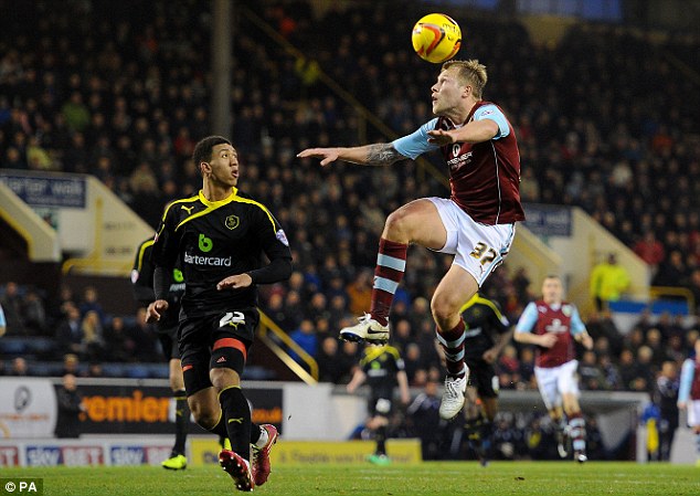 Heads up: Scott Arfield controls the ball as Sheffield Wednesday midfielder Liam Palmer prepares to make a challenge