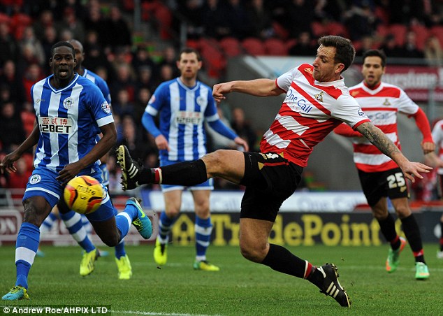 Outstretched: Chris Brown gets on the end of a low Paul Keegan cross to open the scoring for Doncaster