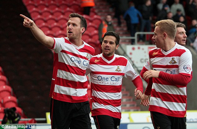 Intensity: Brown laps up the attention from the home crowd as he makes the score 1-0 after eight minutes