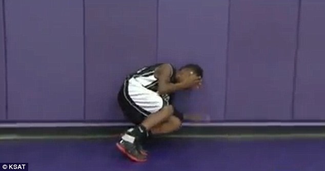 Derrick runs over to the wall and falls down in tears because he is so overwhelmed