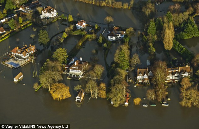 Houses are threatening by the water in Cookham, Berkshire after the River Thames burst its banks and flooded homes and gardens worth millions