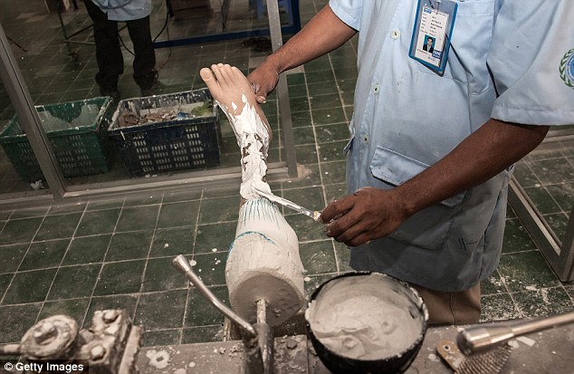 Finishing off: A craftsman is shown partway through building a prosthetic leg