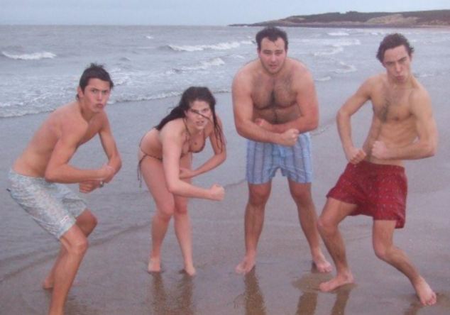 Macho man: James, right, strikes a rugged pose with hardy friends after a New Year's Day dip in the North Sea