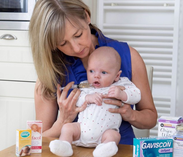 Comfort: Sadie Nicholas and her young son Albie, giving him gripe water through a syringe