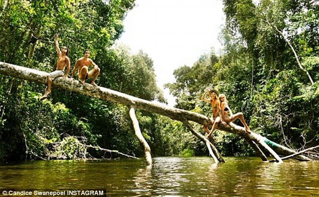 Hanging out: The Victoria's Secret stunner relaxed on a fallen tree trunk above a green lagoon with her pals in this snapshot she posted on Friday