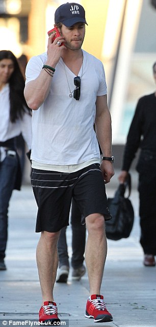 Running errands: Chris Hemsworth was seen chatting on his phone as he dashed around Los Angeles