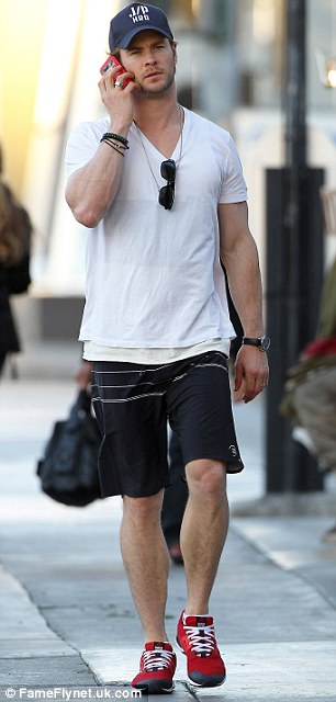 Running errands: Chris Hemsworth was seen chatting on his phone as he dashed around Los Angeles