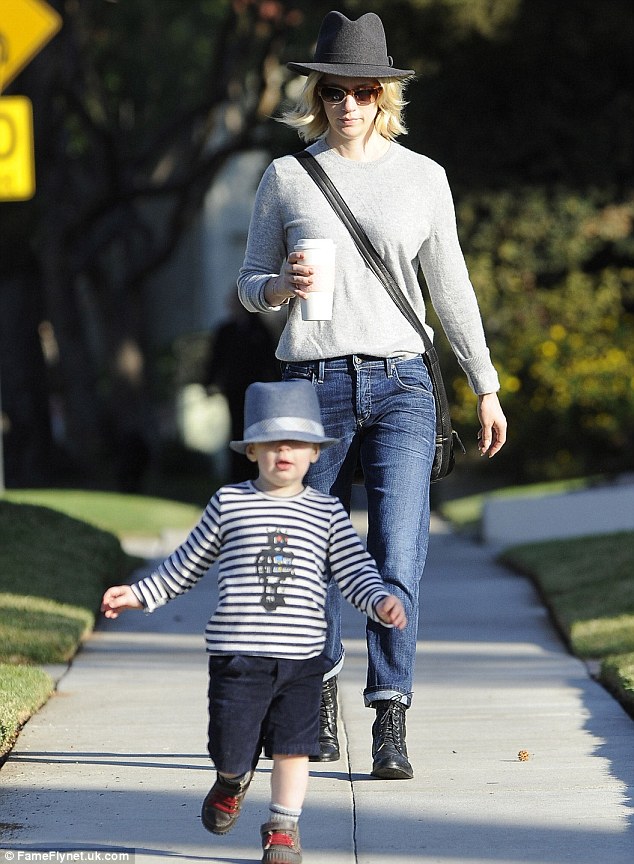 Peekaboo: Xander's eyes are covered by his large hat as he tries to run ahead of his mum